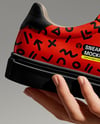 Woman's Hand Holding Sneaker Mockup
