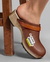Pair of Clogs on Woman's Legs Sitting on Stool Mockup