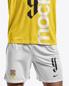 Man Wearing Soccer Jersey and Shorts Mockup