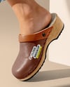 Pair of Clogs on Woman's Legs Sitting on Block Mockup