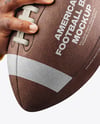 American Football Ball in a Hand Mockup