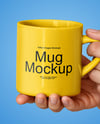 Woman Holding Glossy Mug in a Hands Mockup
