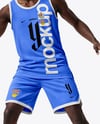 Basketball Player Wearing a Crew Neck Jersey and Shorts Holding a Basketball Mockup