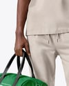 Man Wearing T-Shirt and Sweatpants Holding Duffle Bag Mockup
