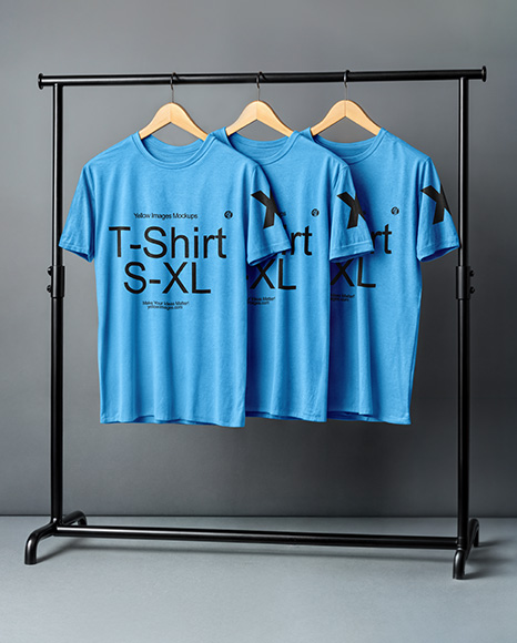 Three T-Shirts on a Wooden Hanger Against a Plain Background Mockup