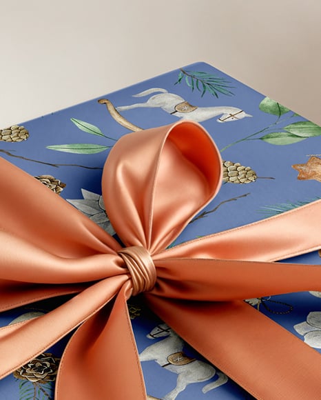 X-mas Gift Box with Bow and Decorations on Background Mockup
