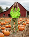 Young Woman in Sweatshirt and Joggers Standing on Hay Block at Pumpkin Patch Mockup