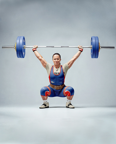 Woman Wearing Weightlifing Suit with Barbell Mockup