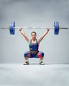 Woman Wearing Weightlifing Suit with Barbell Mockup