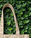 Tote Bag on a Green Leafy Background Mockup