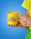 Woman Holding Glossy Mug in a Hands Mockup