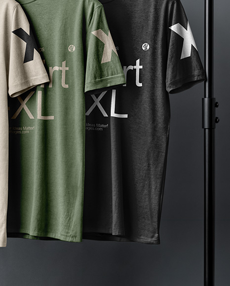 Three T-Shirts on a Wooden Hanger Against a Plain Background Mockup