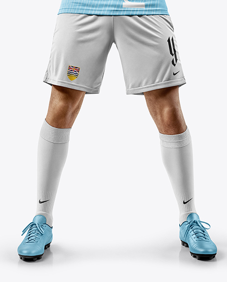 Man Wearing Soccer Jersey and Shorts Holds Cup Mockup