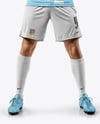 Man Wearing Soccer Jersey and Shorts Holds Cup Mockup