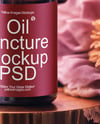 Amber Dropper Bottle with Oil Tincture Surrounded by Flowers Mockup