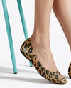 Pair of Suede Ballet Flats on Woman's Legs Mockup