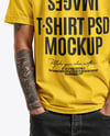 Young Man with Tattoo Wearing T-shirt and Ripped Jeans Mockup
