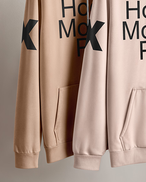 Two Hoodies on a Wooden Hanger Against a Plain Background Mockup