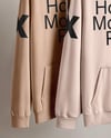 Two Hoodies on a Wooden Hanger Against a Plain Background Mockup