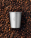 9oz Paper Cup on a Stack of Coffee Beans Mockup
