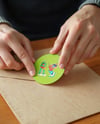 Round Sticker in a Hands Mockup