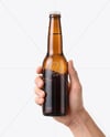 Amber Glass Beer Bottle in a Hand Mockup