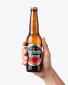 Amber Glass Beer Bottle in a Hand Mockup