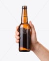 Amber Glass Beer Bottle in a Hand Mockup