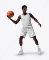 Basketball Player Wearing a Crew Neck Jersey and Shorts Holding a Basketball Mockup