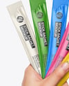 Five Sachets in a Hand Mockup