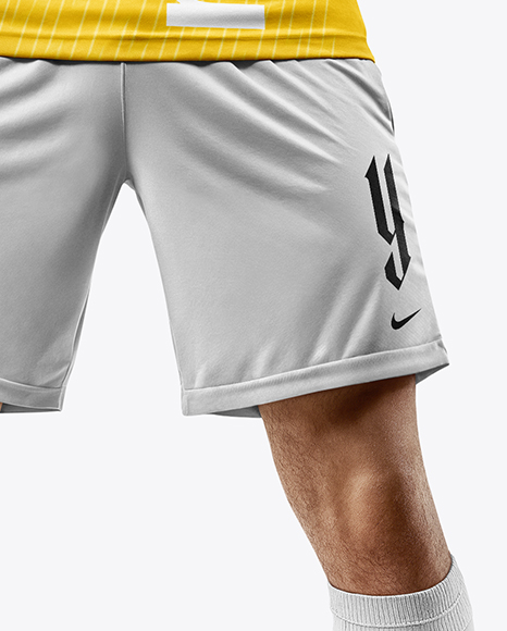 Man Wearing Soccer Jersey and Shorts Holds Cup Mockup