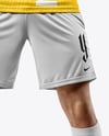 Man Wearing Soccer Jersey and Shorts Holds Cup Mockup