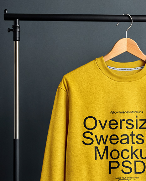 Sweatshirt on a Wooden Hanger Against a Plain Background Mockup