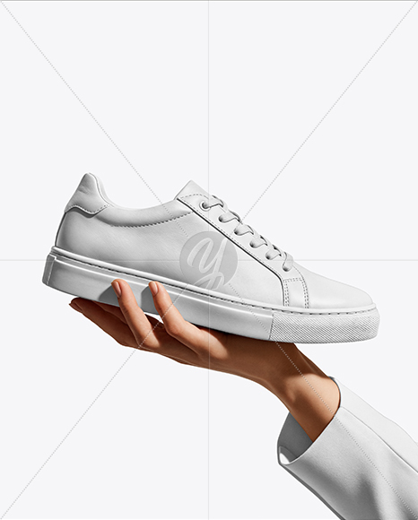 Woman's Hand Holding Sneaker Mockup