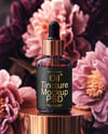 Amber Dropper Bottle with Oil Tincture Surrounded by Flowers Mockup