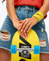 Woman Wearing Sleeveless Shirt and Jean Shorts with Skateboard Mockup