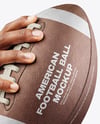 American Football Ball in a Hand Mockup