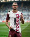 Soccer Player Wearing a Full Kit at the Stadium Mockup