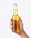 Clear Glass Beer Bottle in a Hand Mockup
