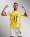 Man Wearing Soccer Jersey and Shorts Mockup