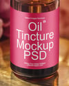 Amber Dropper Bottle with Oil Tincture Surrounded by Flowers Mockup