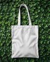 Tote Bag on a Green Leafy Background Mockup