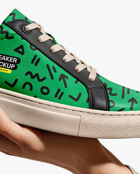 Woman's Hand Holding Sneaker Mockup