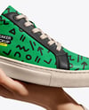 Woman's Hand Holding Sneaker Mockup