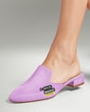 Pair of Suede Mules on Woman's Legs with Skirt Mockup