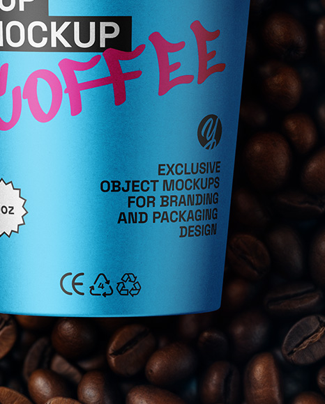 9oz Paper Cup on a Stack of Coffee Beans Mockup