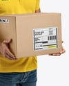 Delivery Man Wearing Polo Shirt and Cap Holding Box Mockup