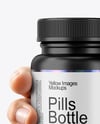 Plastic Pill Bottle in a Hand Mockup