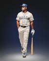 Black Man Wearing a Full Baseball Kit with Bat Mockup
