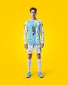 Man Wearing Long Sleeve Raglan Soccer Jersey and Shorts Mockup